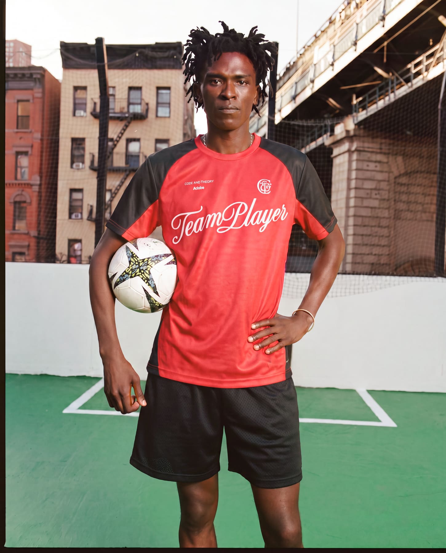 Player wearing the TeamPlayer jersey, holding a soccer ball