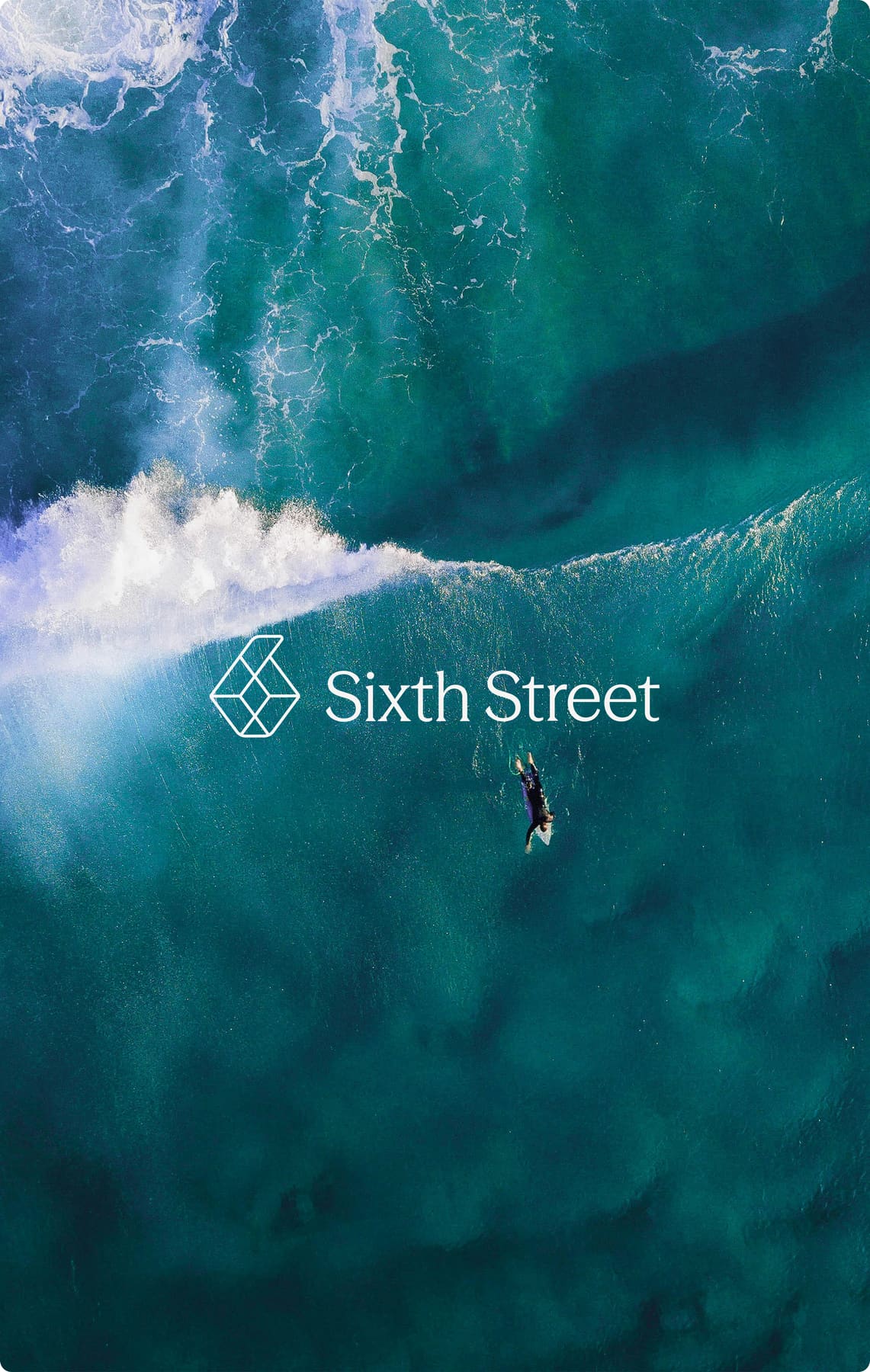 Aerial photo of a surfer and wave with the Sixth Street logo